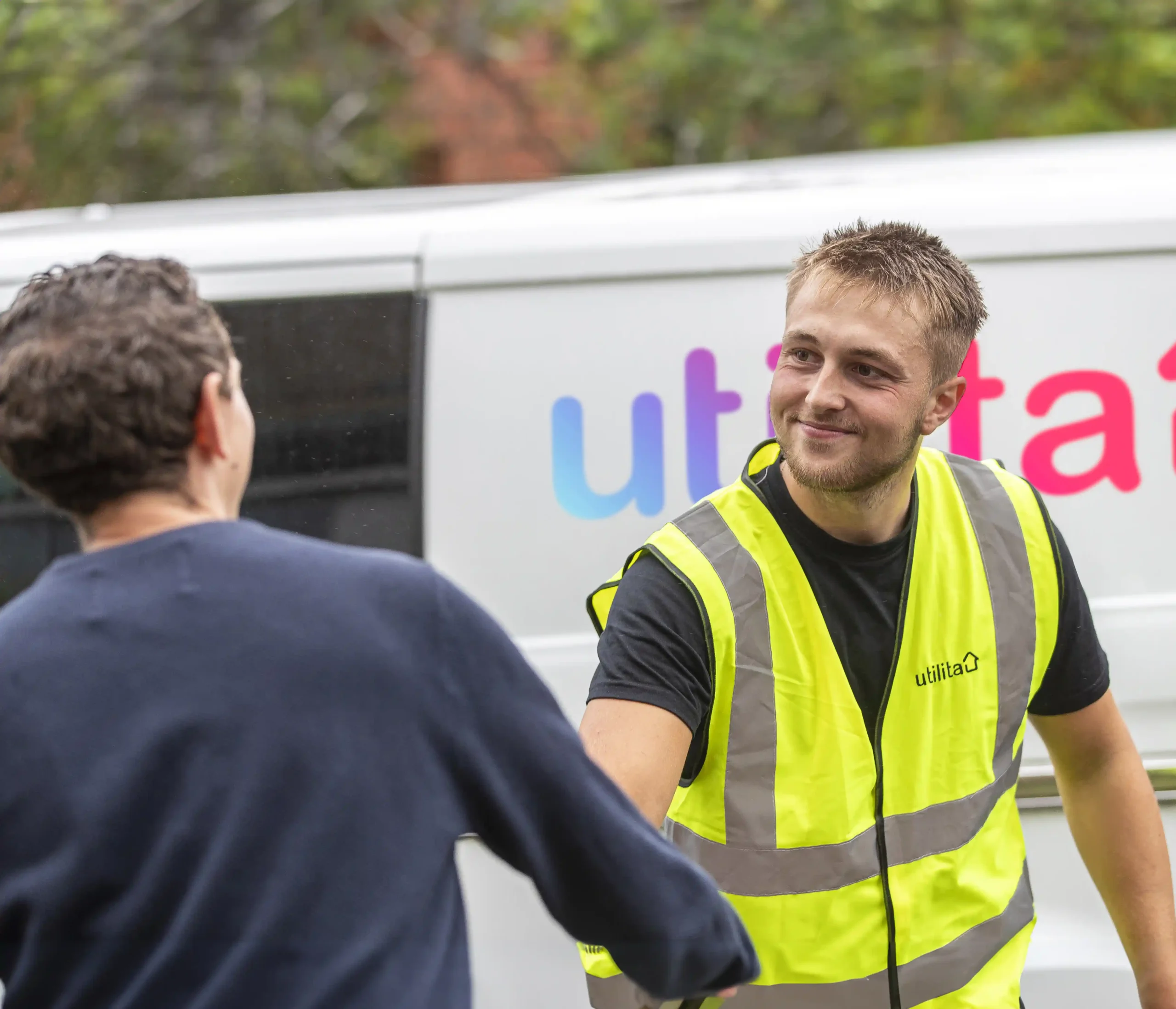 Utilita Business engineer shaking hands with a hospitality & leisure client looking to install commercial solar panels.